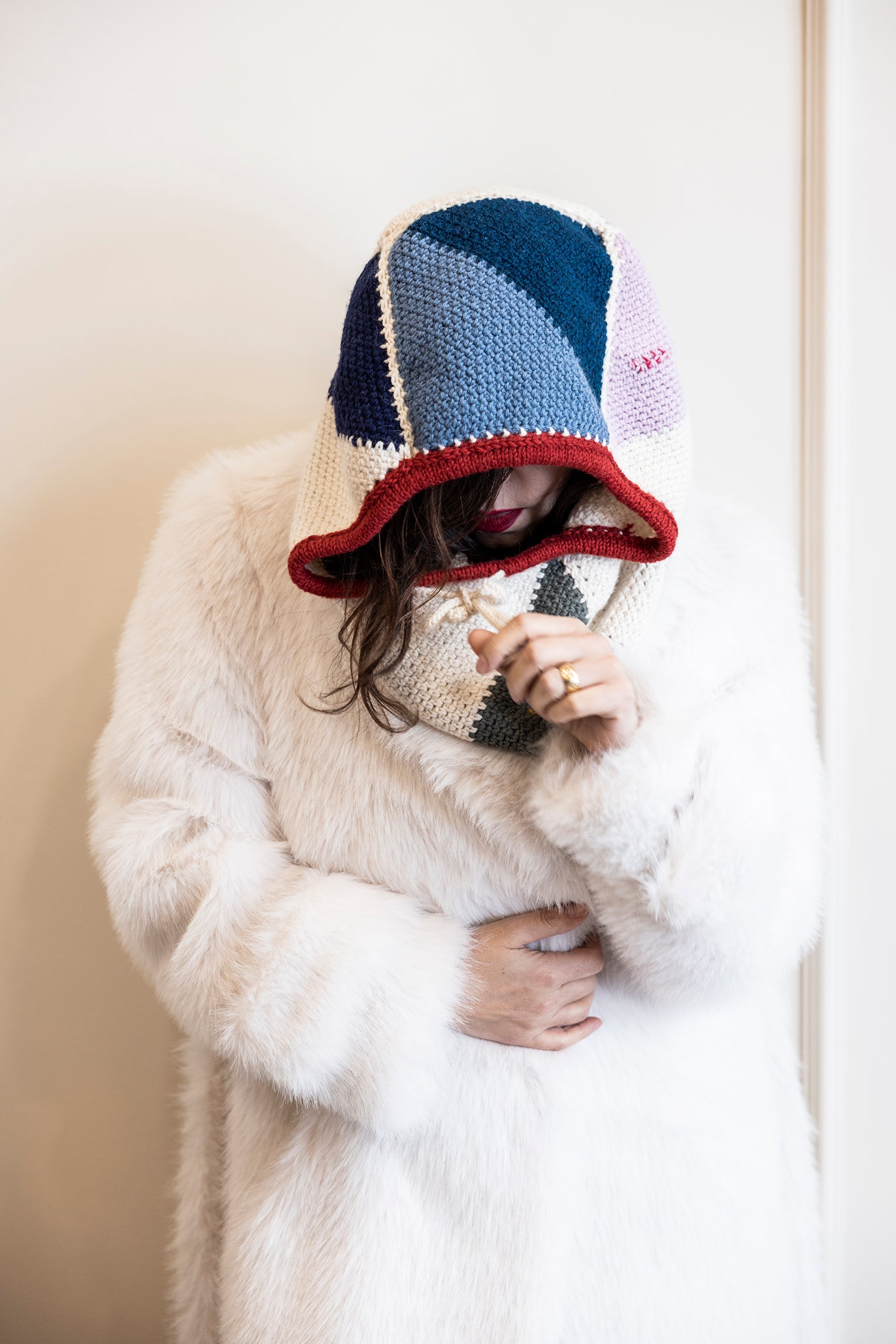 Ebru is wearing a crochet balaclava hat